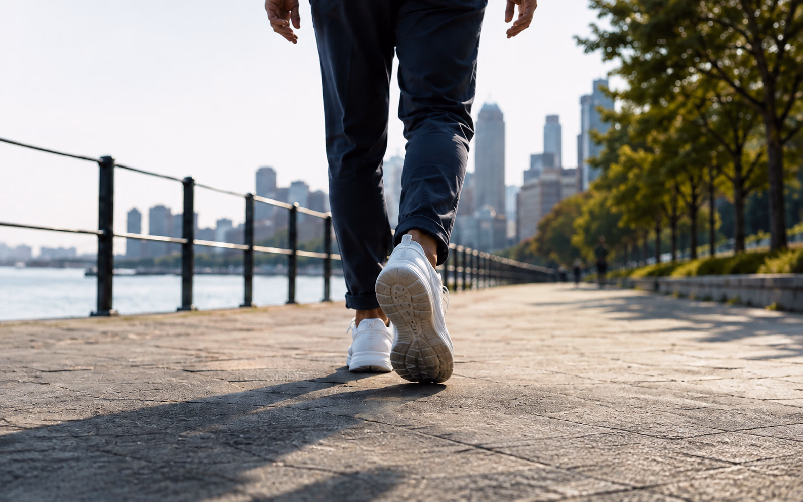 A person walking beside an urban waterfront